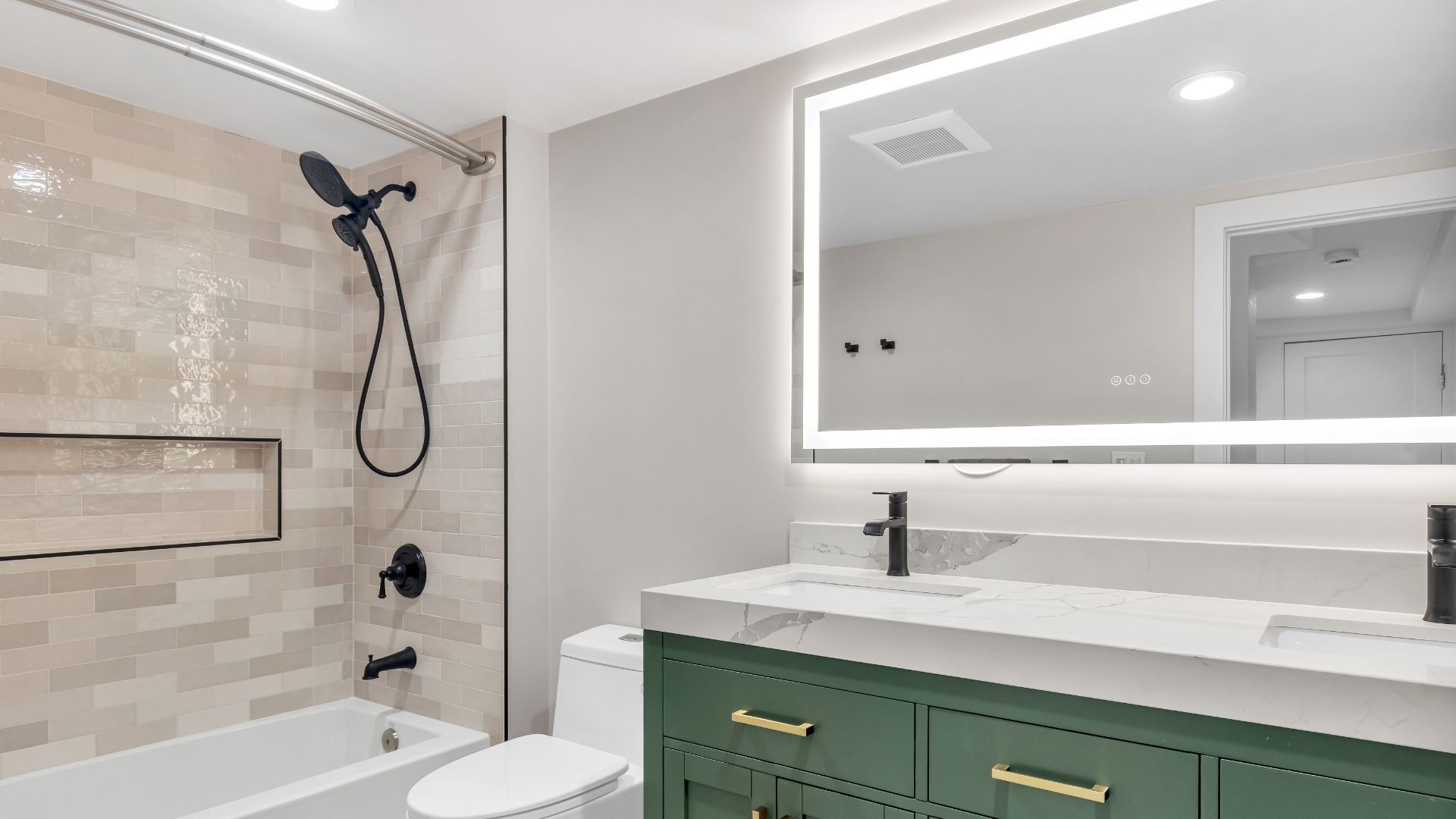 remodeled bathroom with backlit mirror