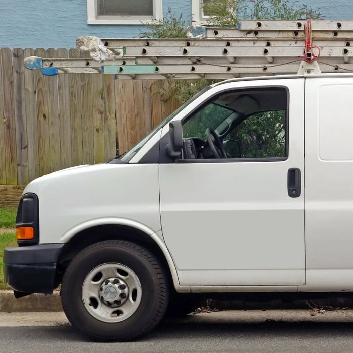 white van with ladder on roof