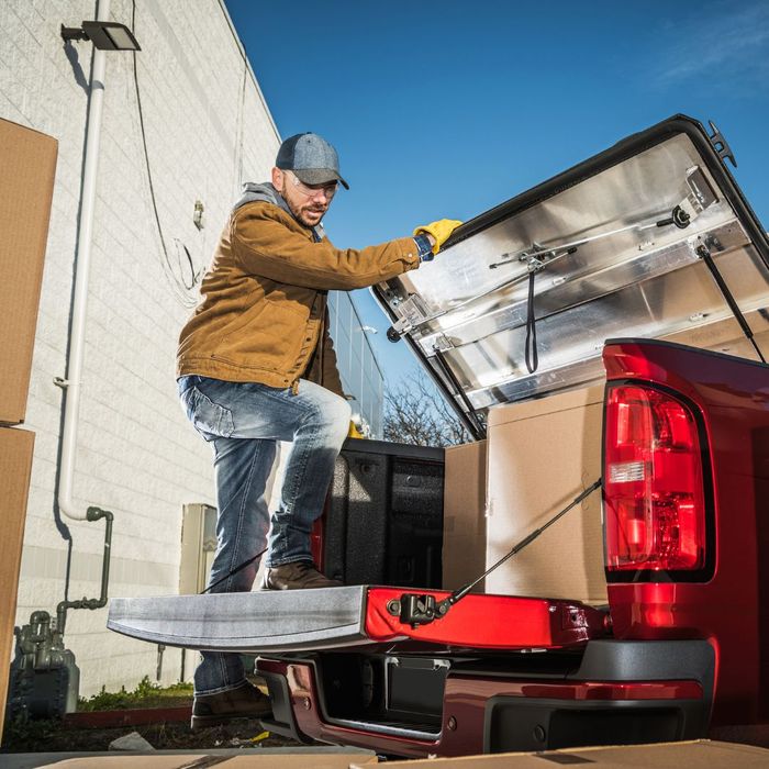 loading boxes into a red truck bed