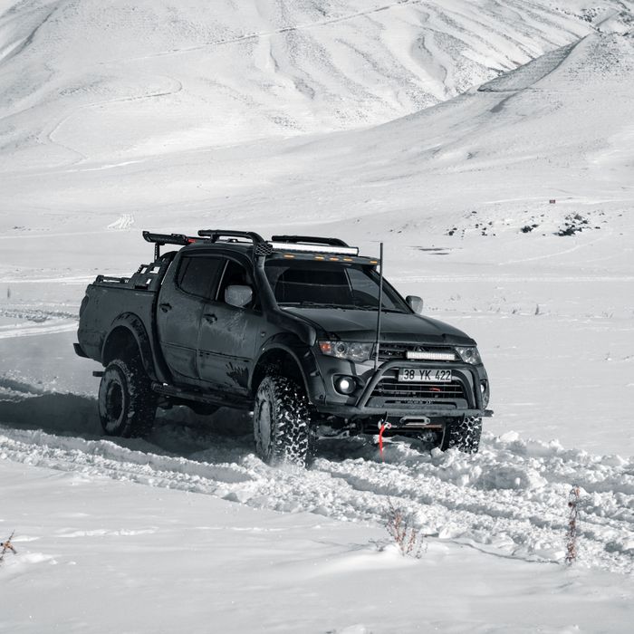 Truck driving through snow