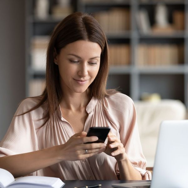 woman checking her phone for alerts