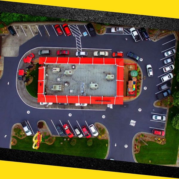 drone view of recently repaved commercial parking lot drone view of recently repaved commercial parking lot