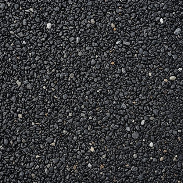 Close-up texture of brand new asphalt pavement that hasn't been sealed yet.