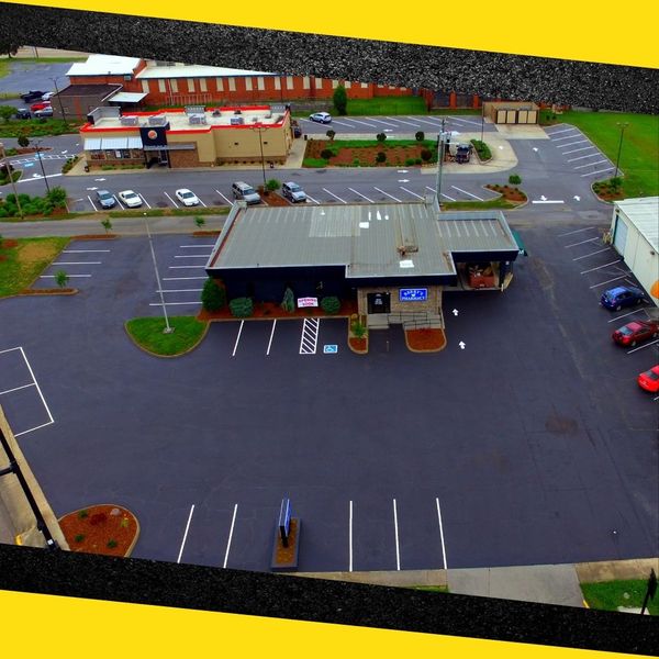 drone view of repaved commercial parking lot drone view of repaved commercial parking lot