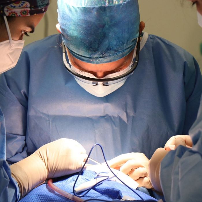 Surgeons performing surgery under bright medical light