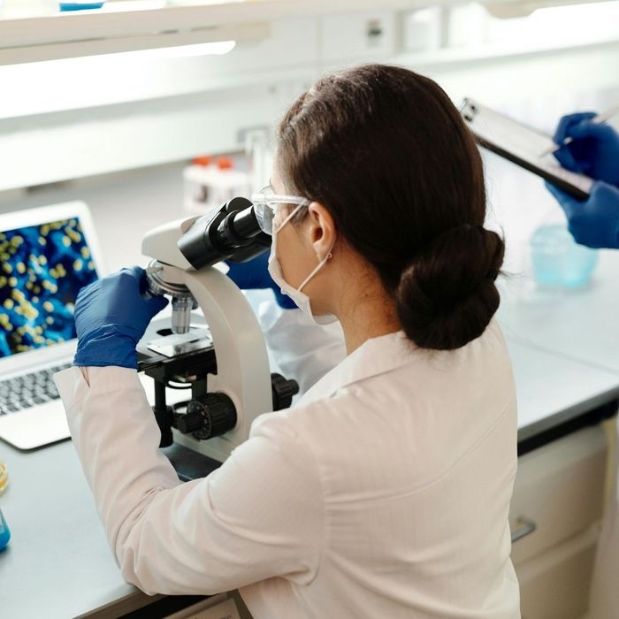 Image of a scientist looking through a microscope