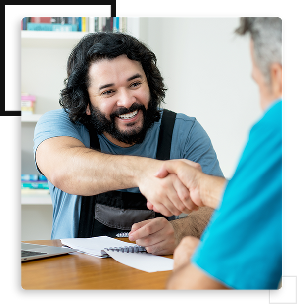 handyman shaking hands with a happy customer