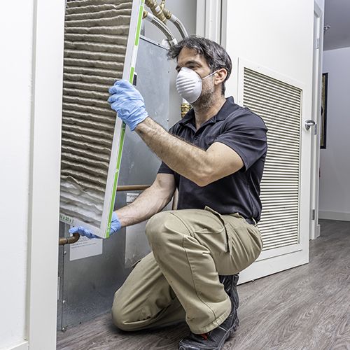 HVAC technician changing air filters