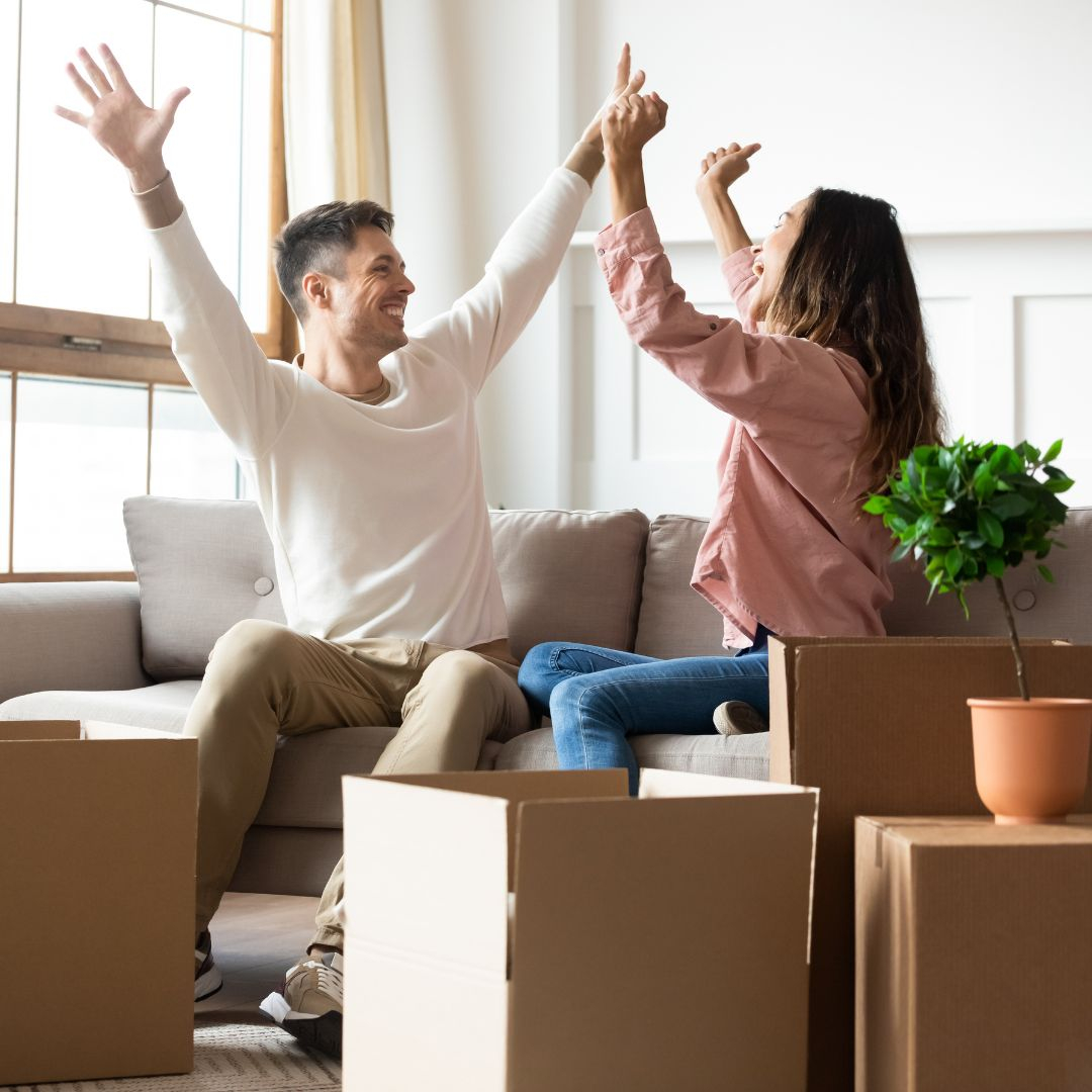 A happy couple celebrate moving into their apartment