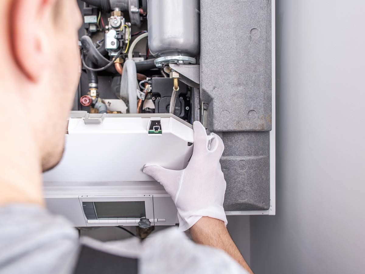 An HVAC repair man fixing a unit