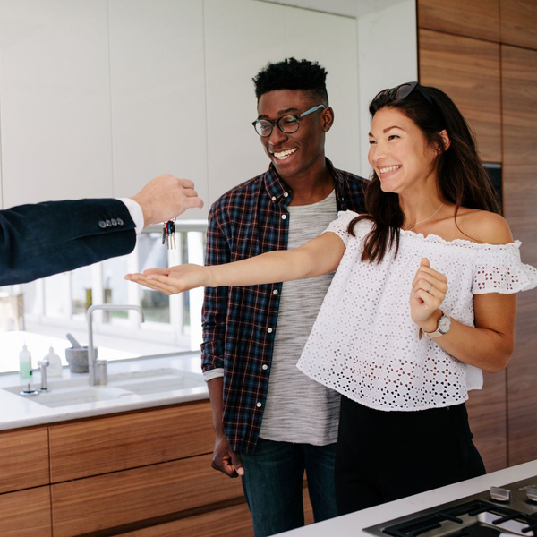 A happy couple gets the keys to their new apartment