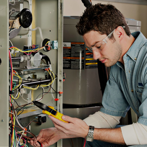 Commercial HVAC technician diagnosing equipment problems.