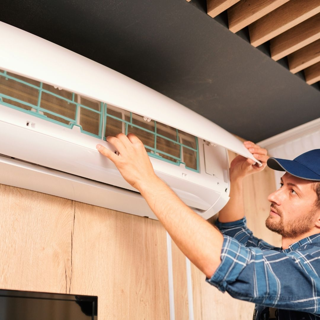 technician inspecting ac unit Residential AC Maintenance in Warwick First.jpg