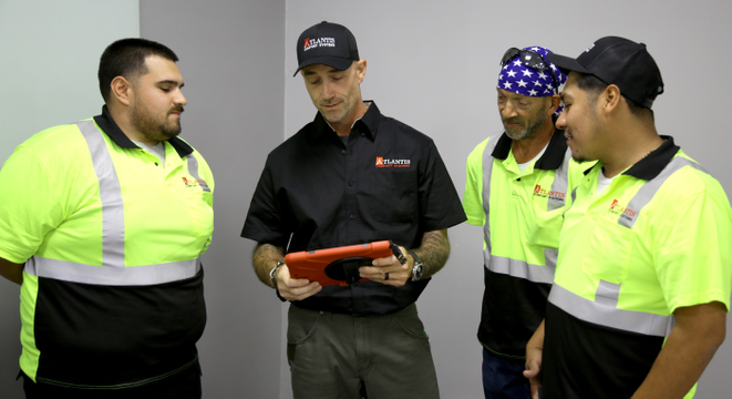 Atlantis Comfort Systems technicians and project managers coordinating a commercial HVAC installation, ensuring quality workmanship, safety, and efficient project execution for businesses and multi-family properties. Commercial HVAC Installation Team