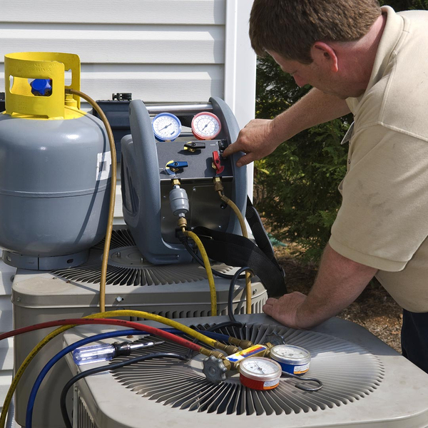 HVAC technician working on an AC unit