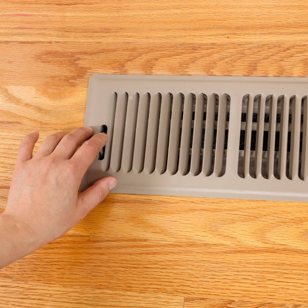 homeowner checking vent in home