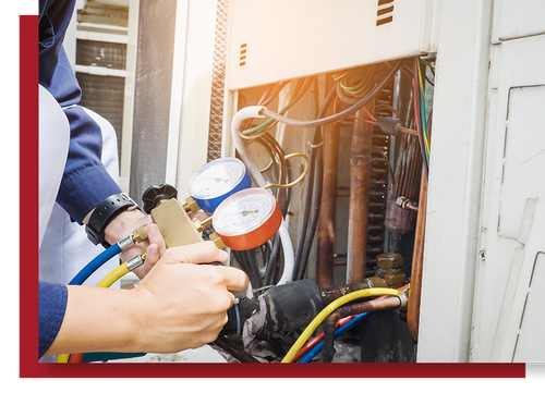 Commercial HVAC technician performing preventative maintenance on rooftop HVAC equipment.