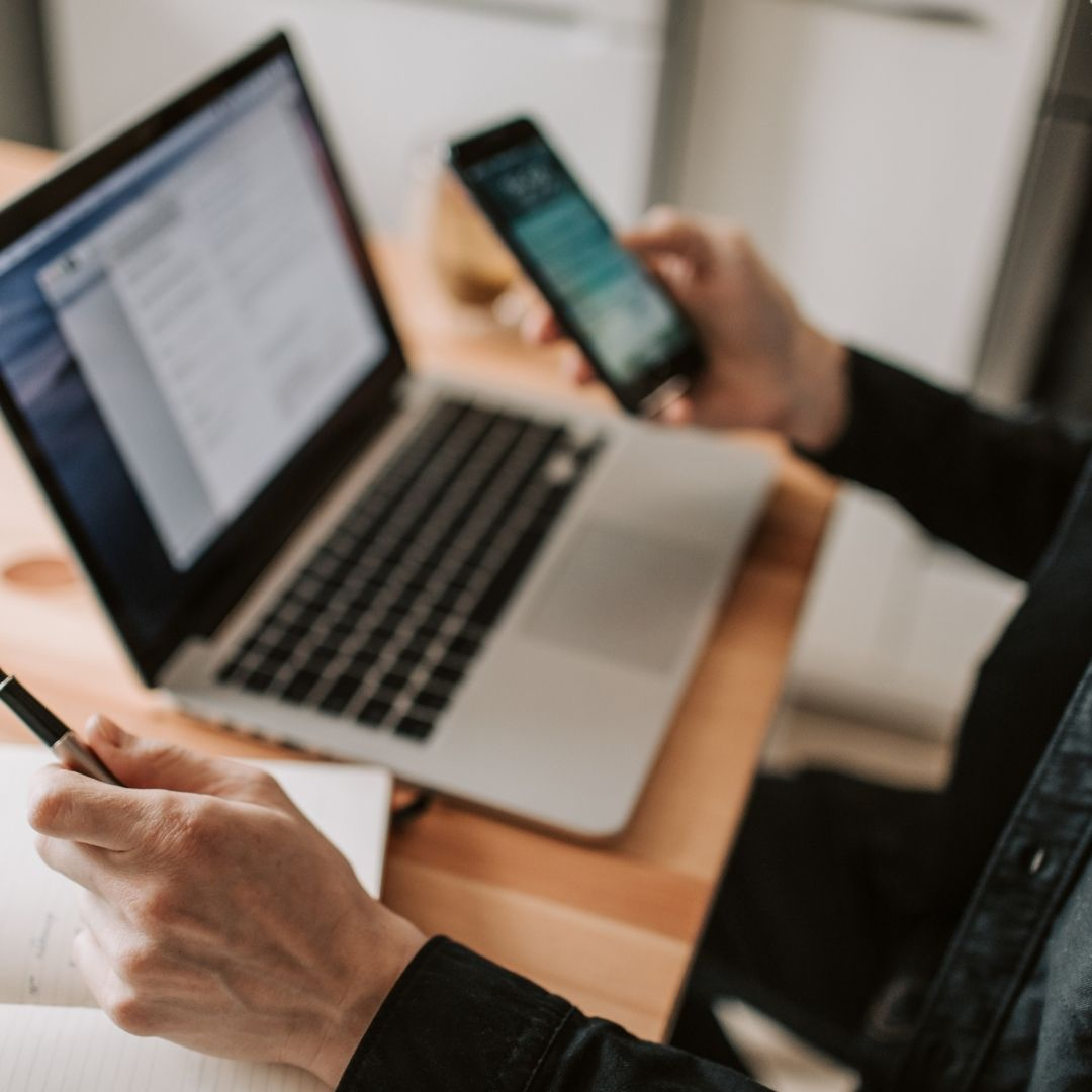 person on laptop and phone