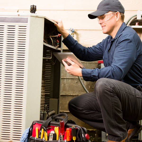 repair technician investigating AC