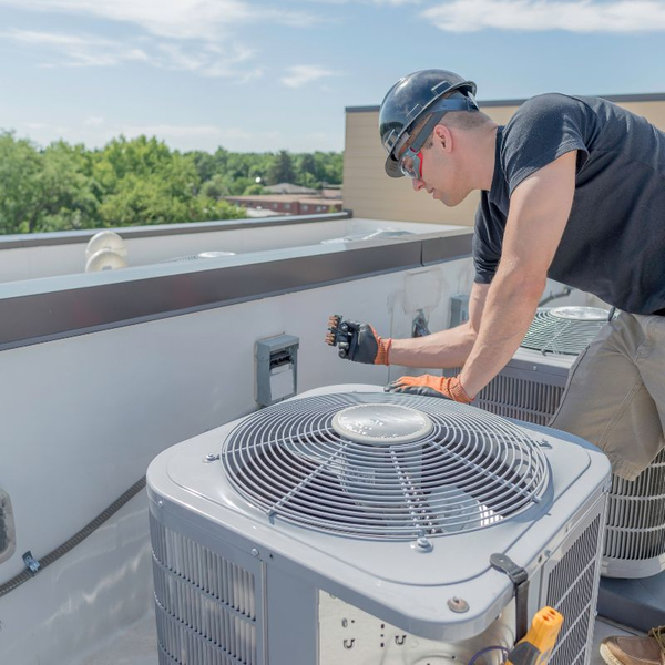 AC repair person on roof