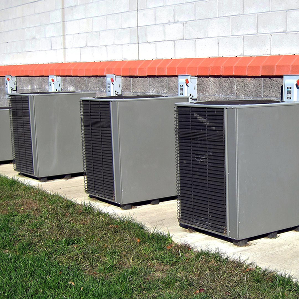 commercial ac units next to a brick building