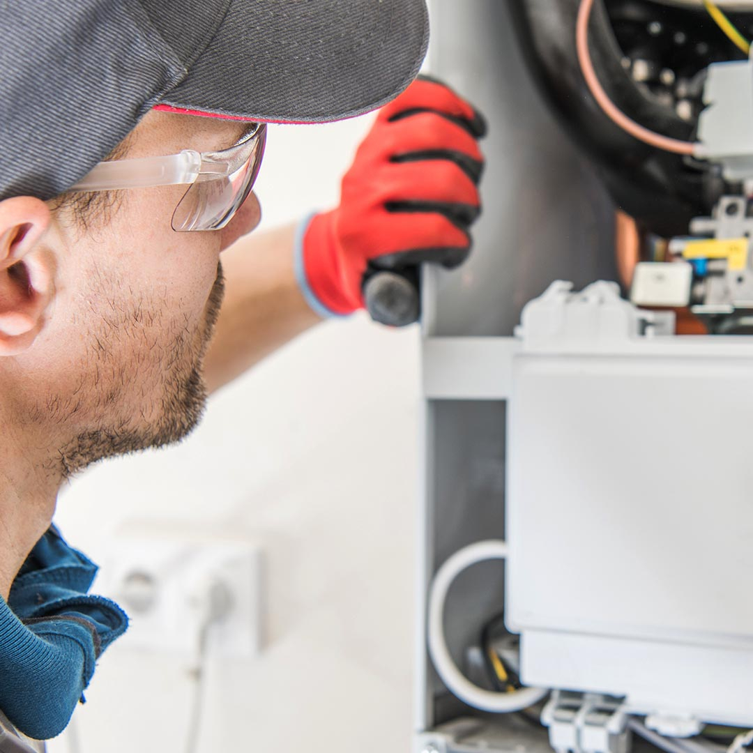 hvac tech repairing a furnace