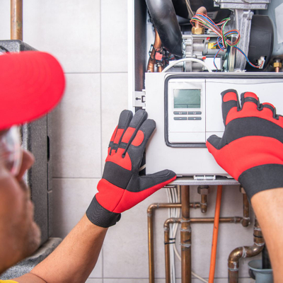 HVAC technician repairing a residential heating and cooling system in Rhode Island.