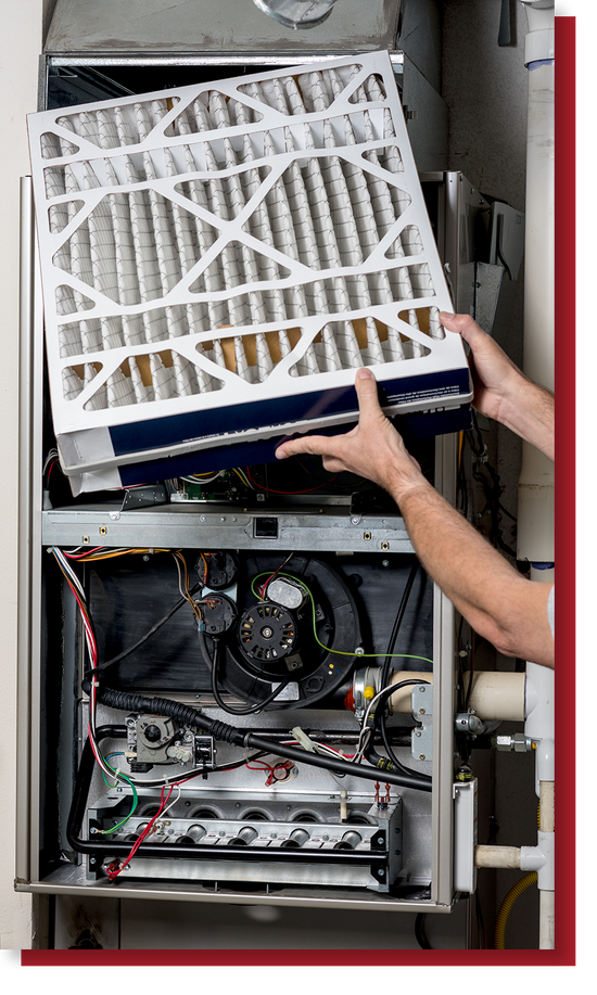 Commercial HVAC technician inspecting HVAC equipment during preventative maintenance.