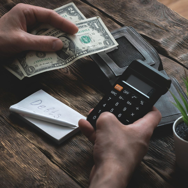 a calculator, money, and debts