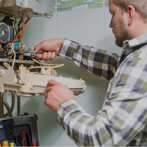 Commercial HVAC technician repairing HVAC equipment.