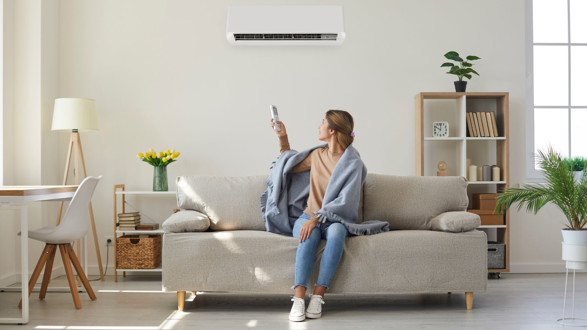 A Woman turns on her AC in her apartment A Woman turns on her AC in her apartment