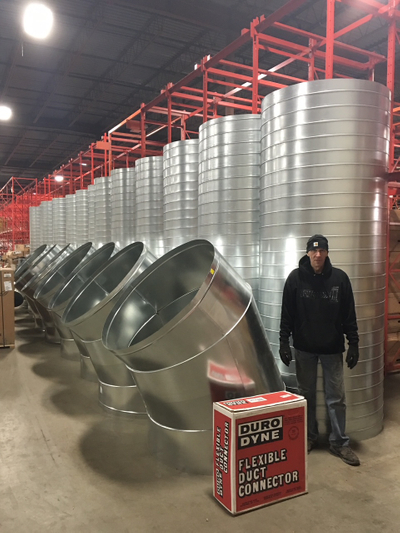 Commercial HVAC technicians installing heating and cooling equipment inside a commercial building.
