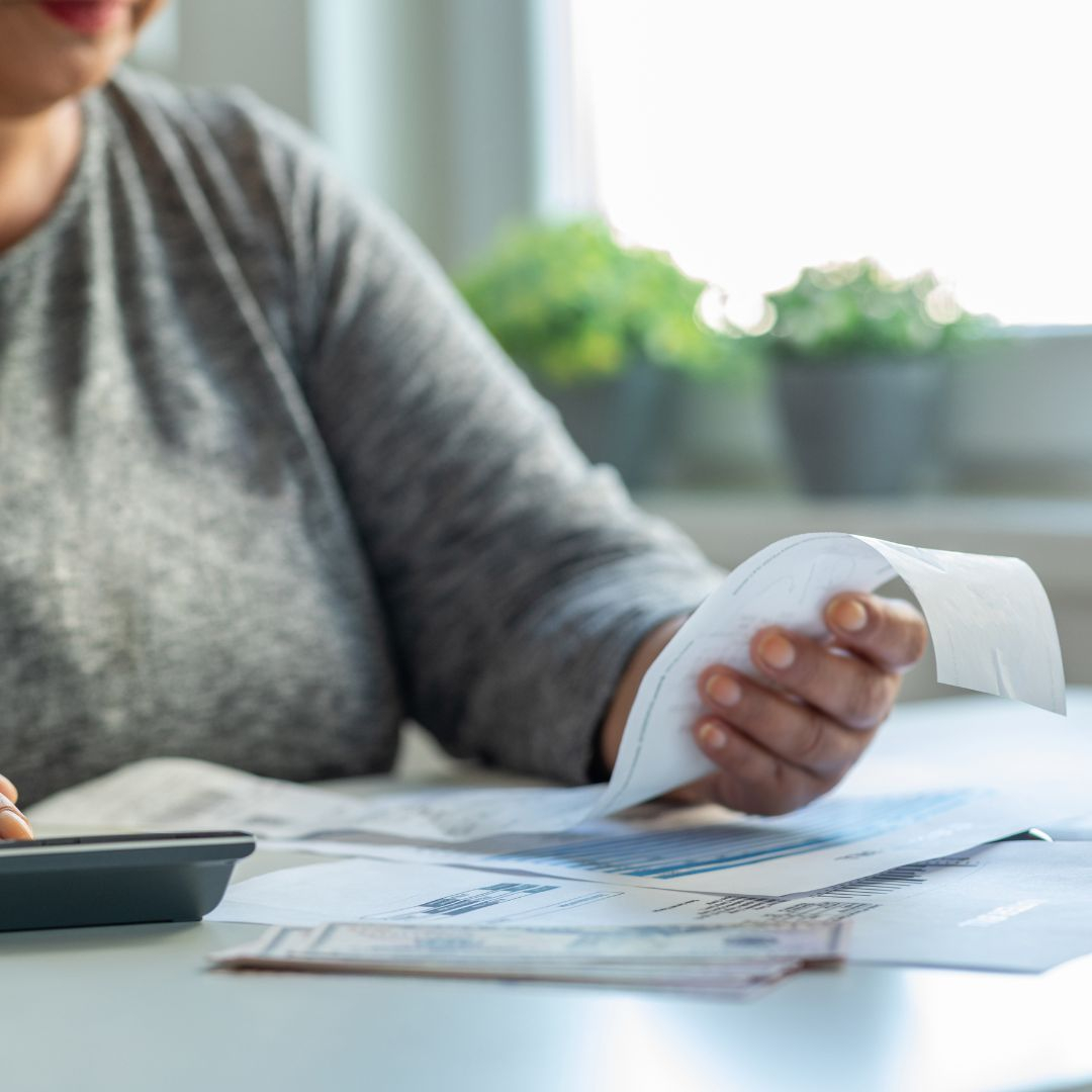 a woman looking at bills