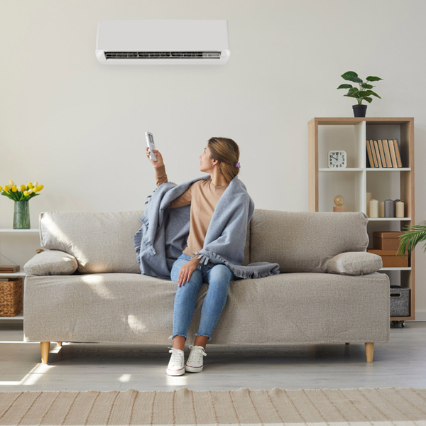 woman using remote on AC