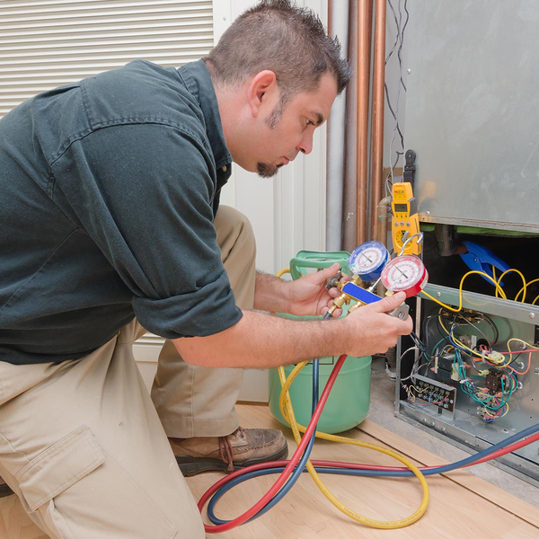 hvac technician inspecting a residential hvac unit