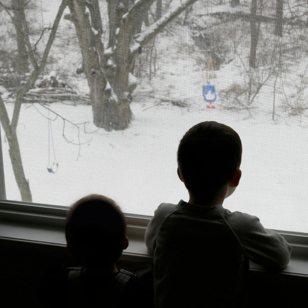 2 boys looking out window