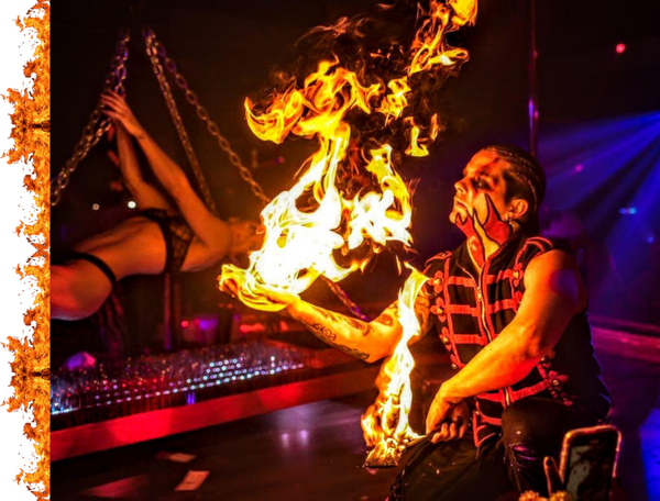 fire performer with a ball of fire in hand