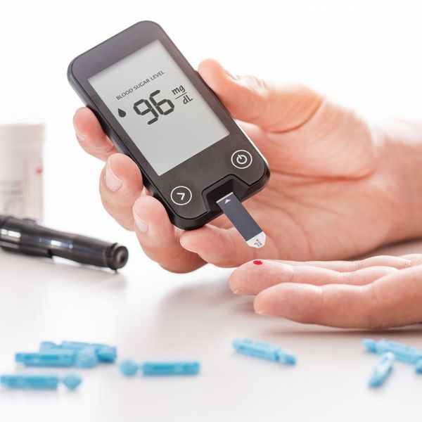 person using a glucose monitor