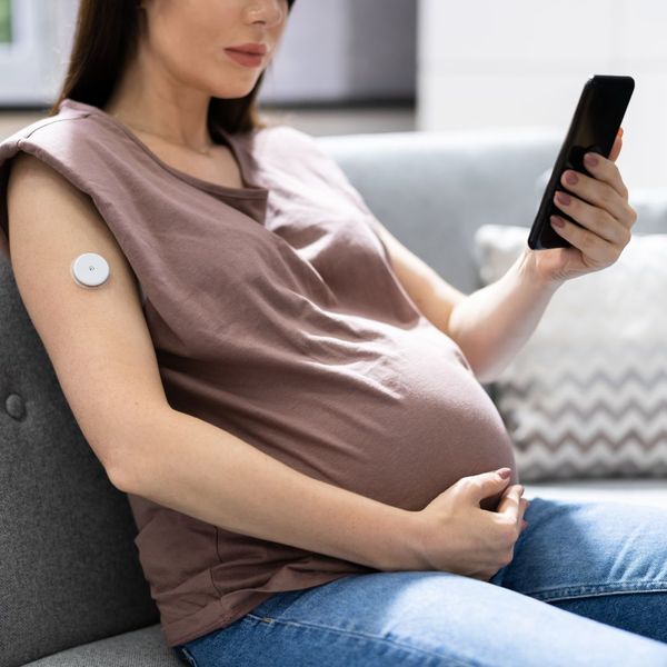 pregnant woman checking cgm system