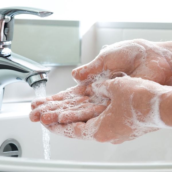 Person washing their hands. 