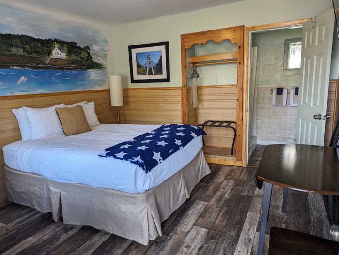 a green and wood accented room with a single bed and closet