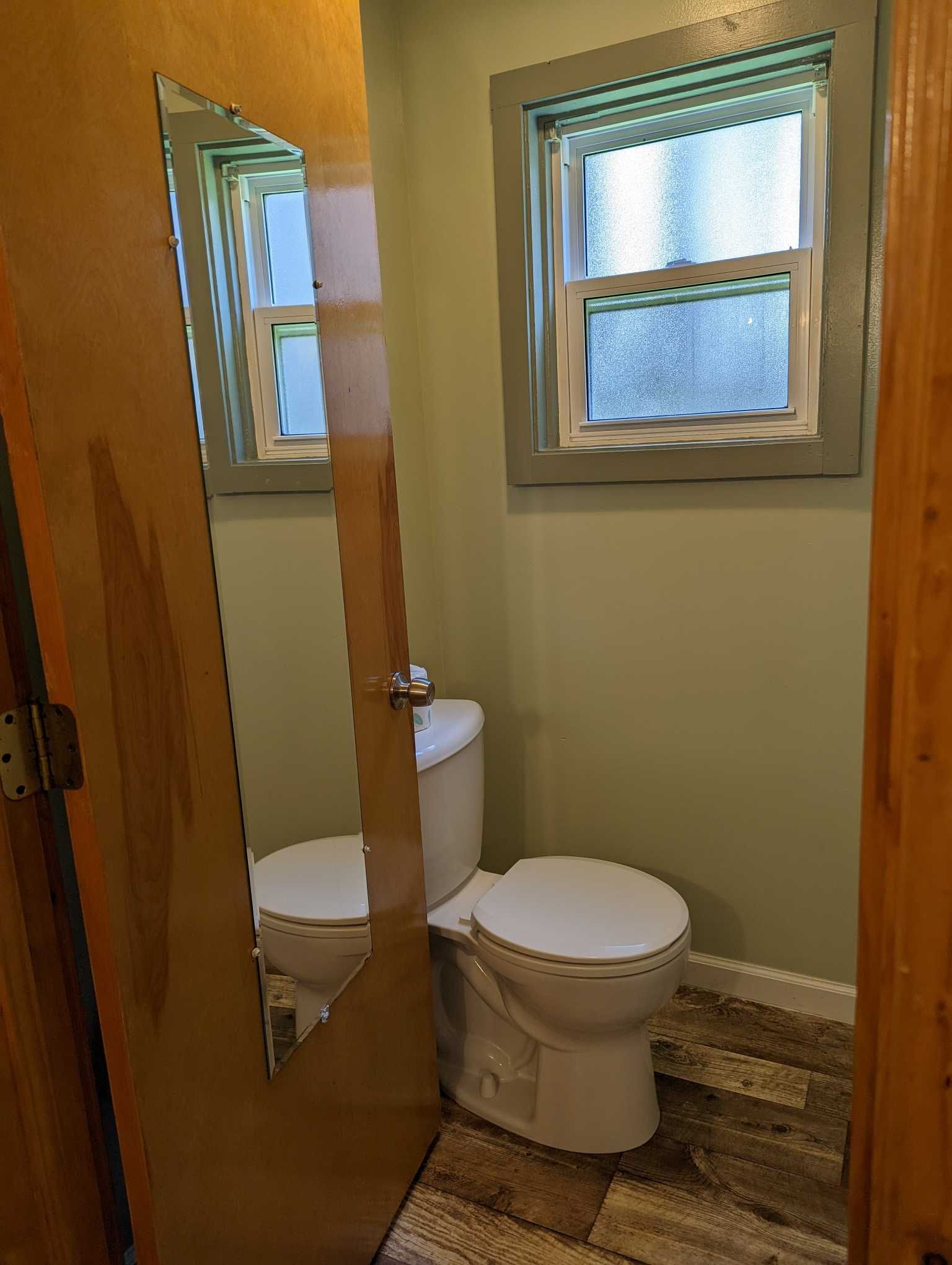 a bathroom with a window and a mirror