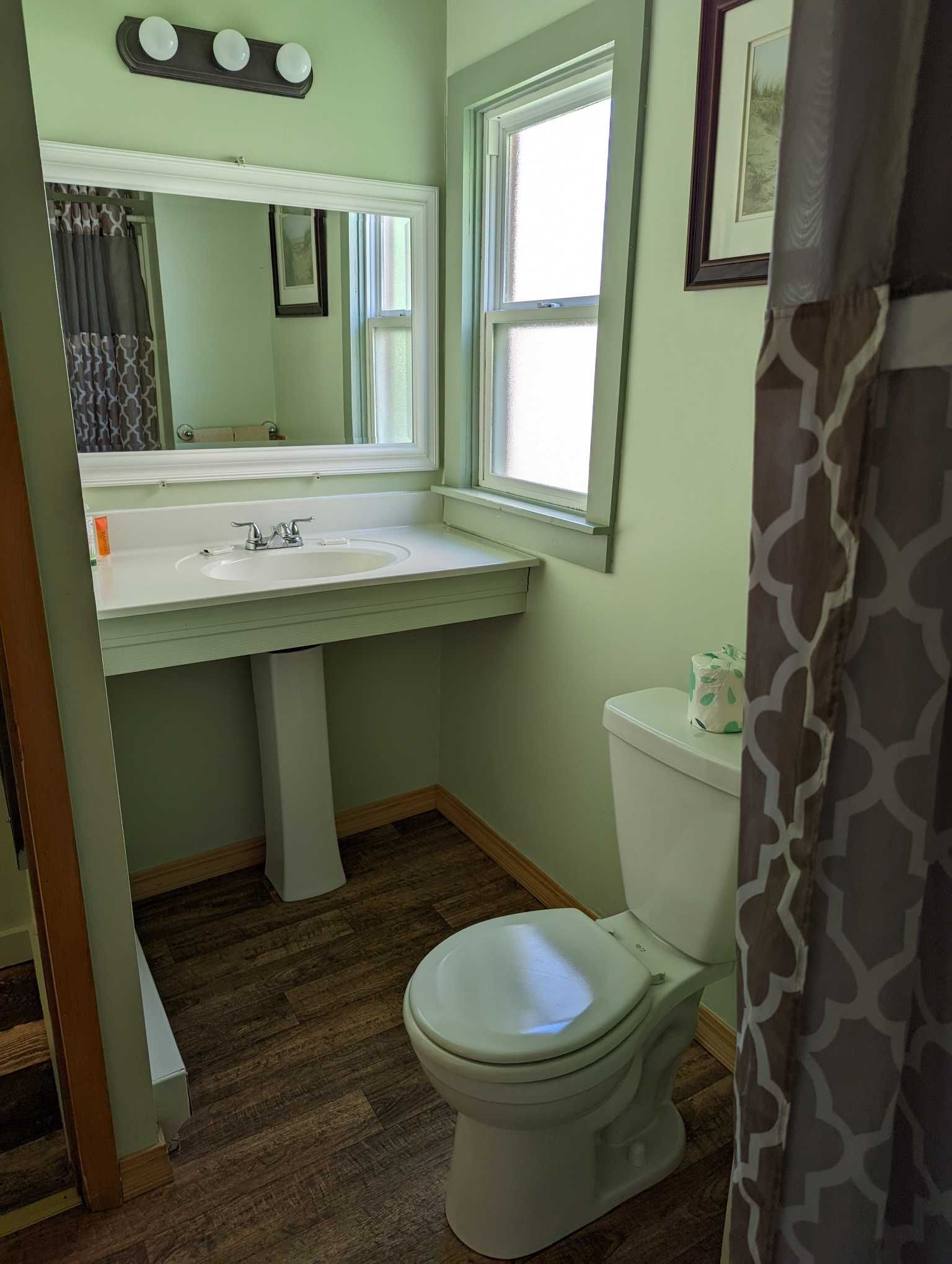 a bathroom with a window and a single sink vanity