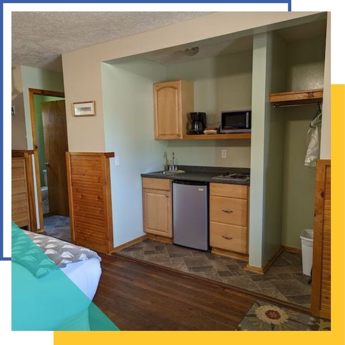 A clean and functional kitchenette area inside a deluxe motel room at Mitchell Creek Inn.
