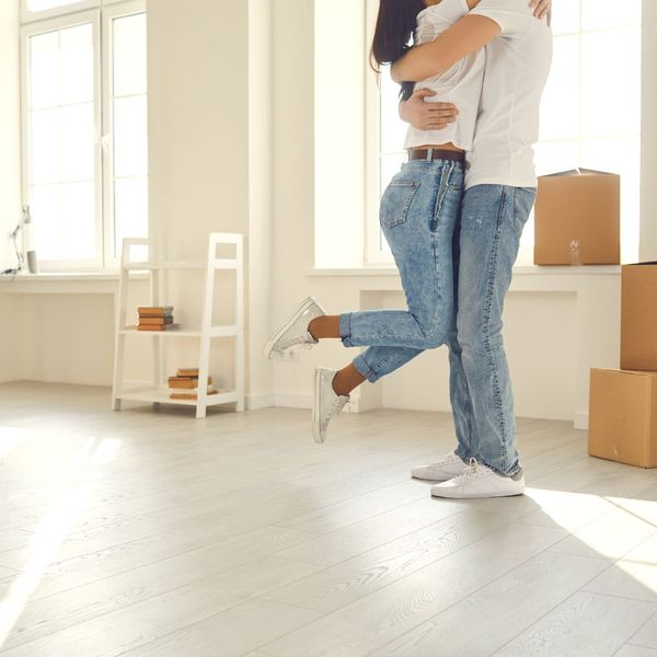 couple hugging while unpacking 