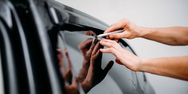 Applying window tint film Applying window tint film