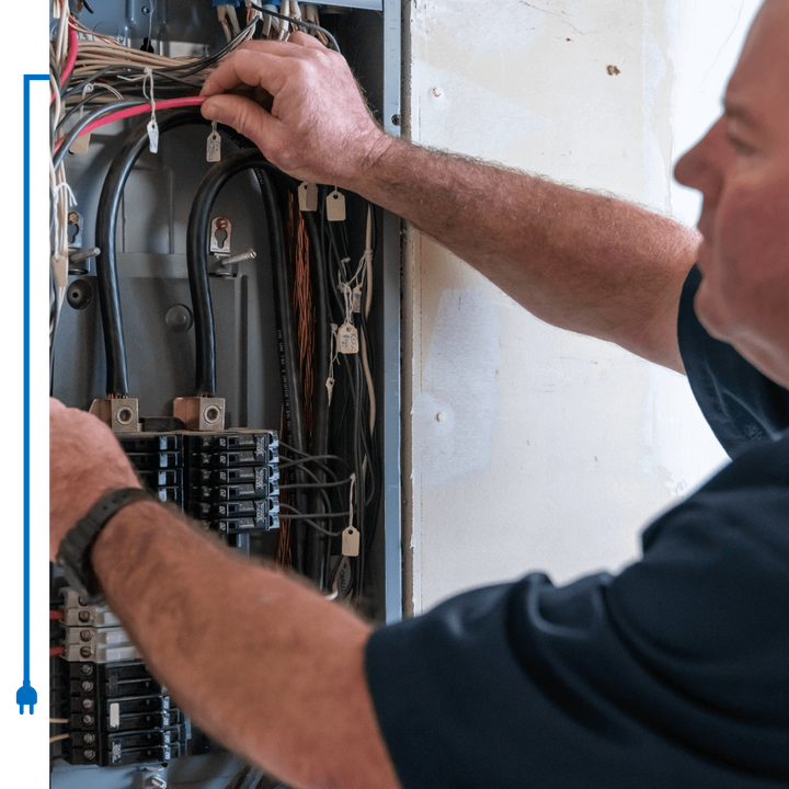 electrician repairing a breaker box electrician repairing a breaker box