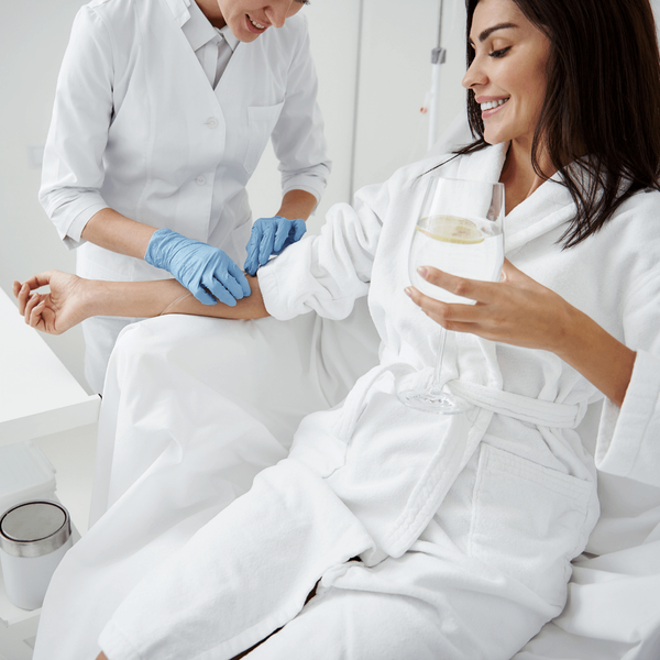A woman in her home getting a wellness IV drip A woman in her home getting a wellness IV drip