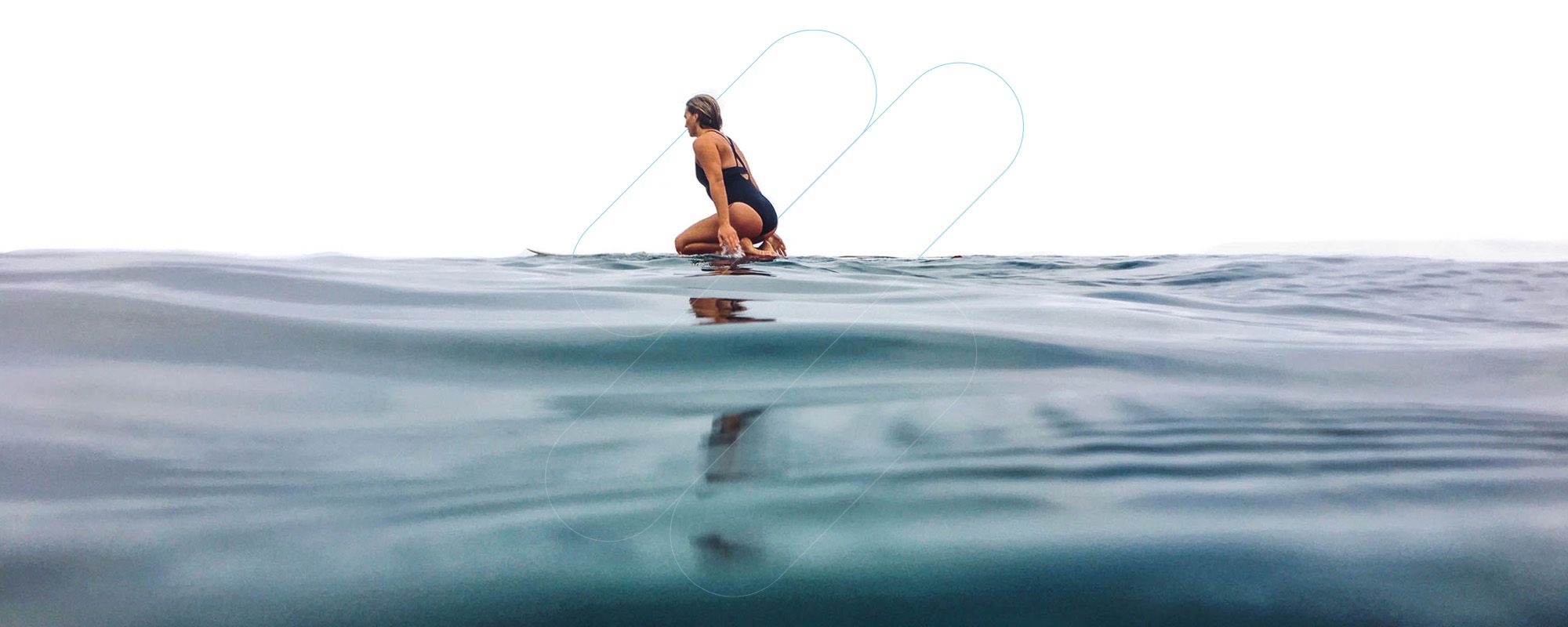 A woman on a surfboard viewed from water level A woman on a surfboard viewed from water level