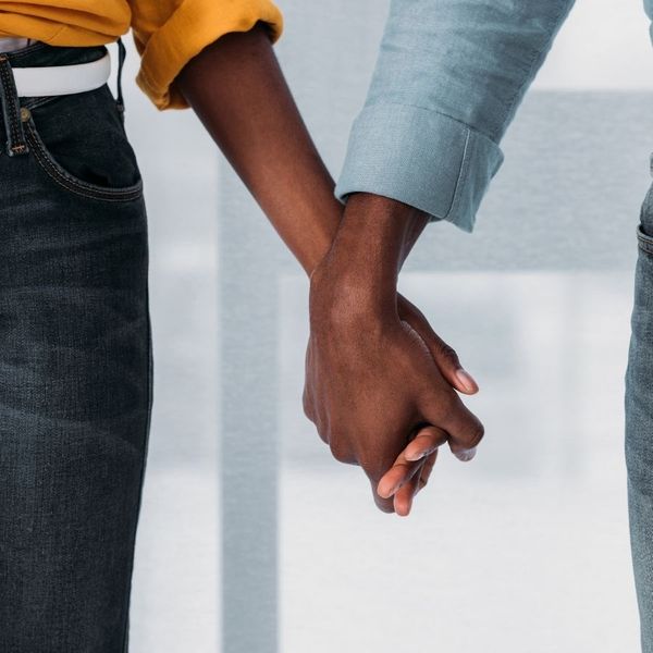 A black couple holding hands.